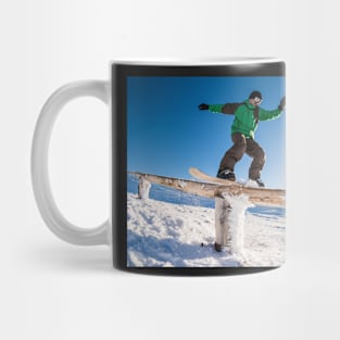 Snowboarder sliding on a rail Mug